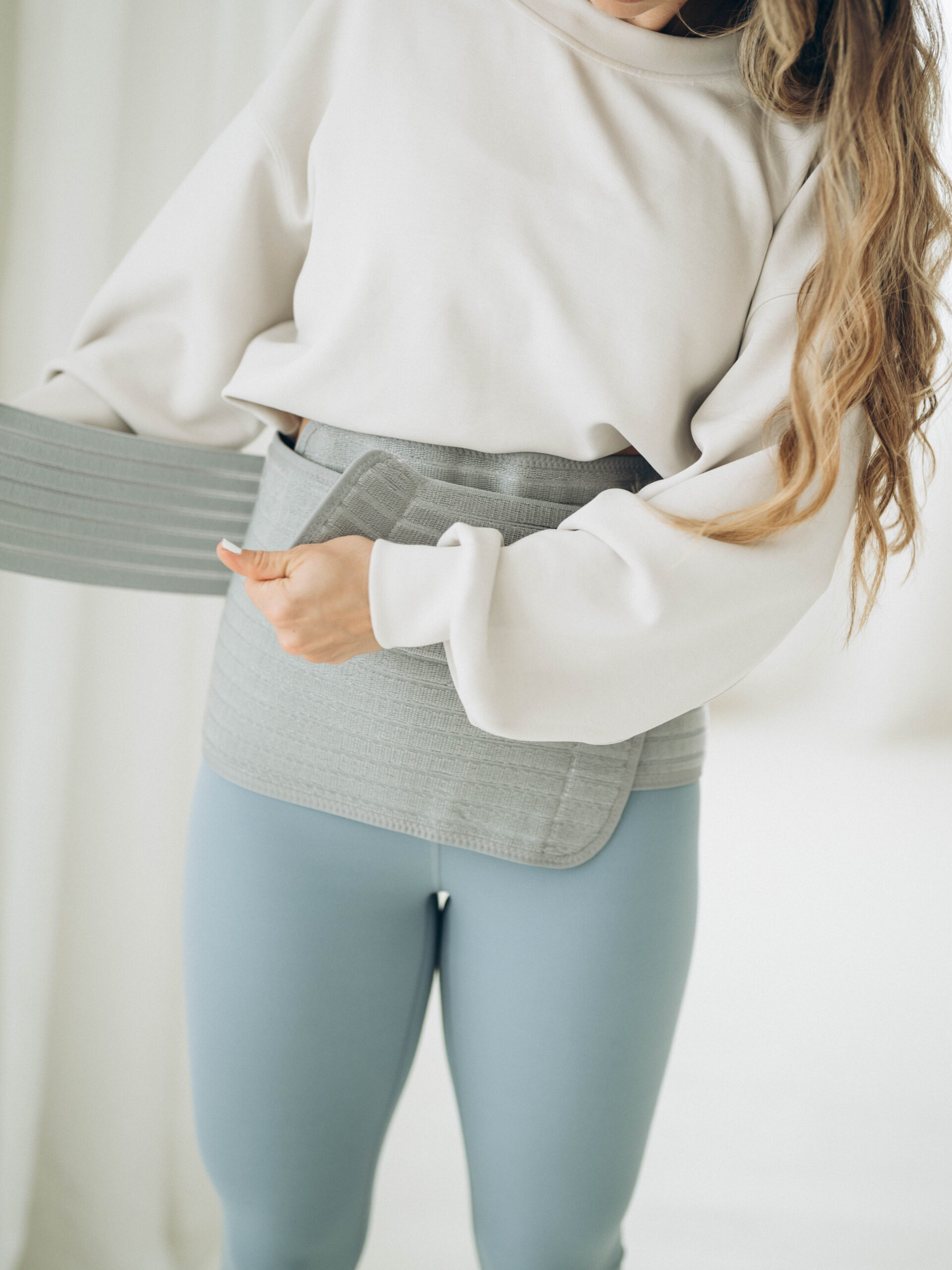 Postpartum support belts and garments